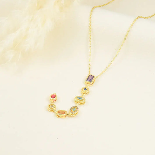 Corbatín dorado con charms