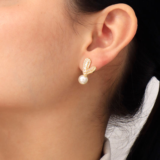 arete-topo-dorado-con-piedra-baguette-y-perla